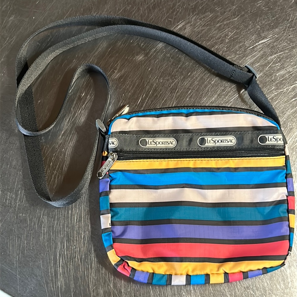 LeSportSac multi colored stripe nylon crossover bag. 8x8x2. Strap adjusts 26”L